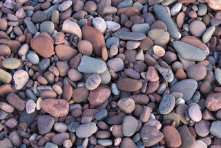 lake edge pebbles at sunset