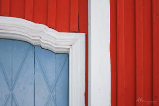 Red, white and blue painted wood on the old church in Jukkasjärvi, Sweden