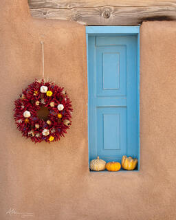 Thanksgiving decorations including a dried chilli pepper wreath, in Ranchos De Taos.