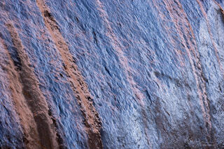 reflection of blue sky on wet orange sandstone along Pine Creek in Zion National Park, Utah