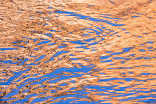 reflections of sandstone walls in the water of the North Fork of Virgin River in the Main canyon in Zion National Park, Utah