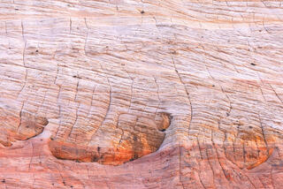 Morning light highlighting cracks in Navajo sandstone in the Clear Creek area of Zion National Park, Utah