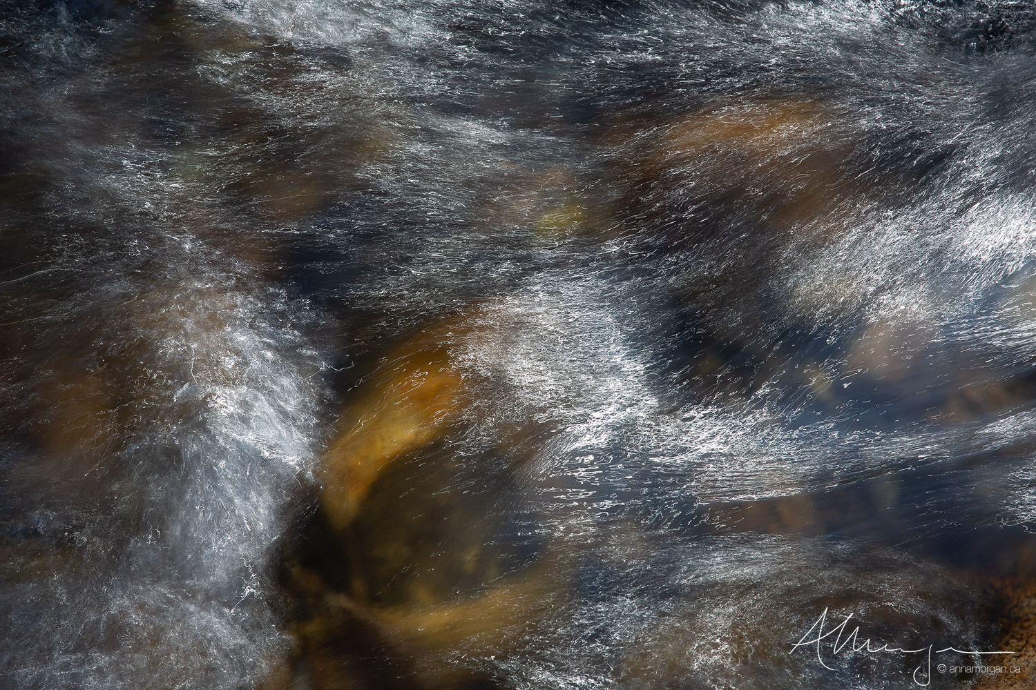 Fast moving water in an alpine creek in the Eastern Sierra glistens in the midday sun creating wonderful patterns on its surface