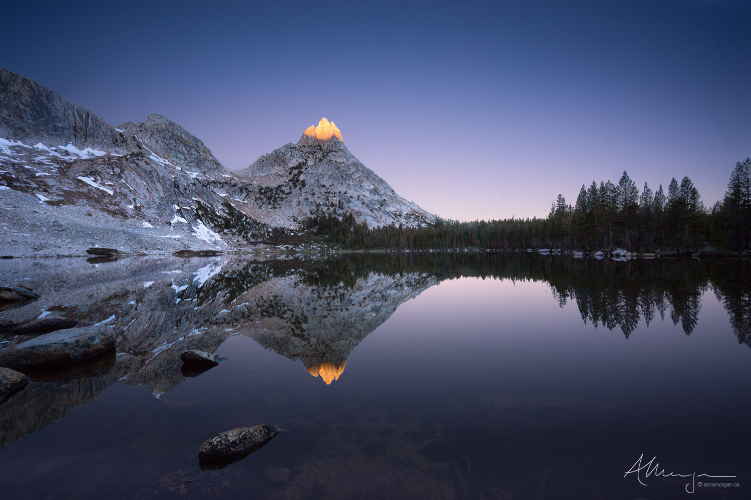 Ragged Glow The sunrise hitting the top of Ragged peak is reflected in Young Lake in the Yosemite backcountry.