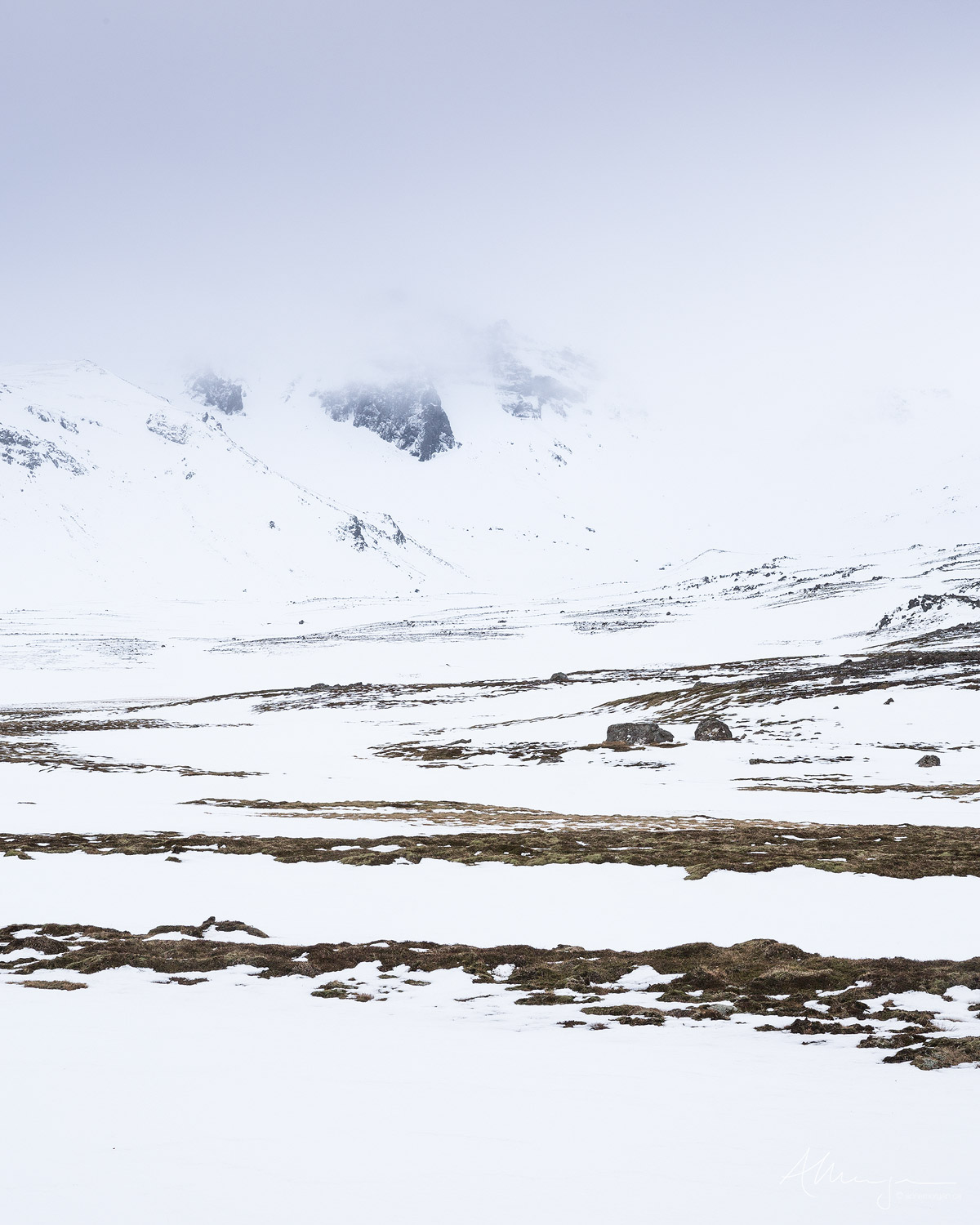 Snow covers the volcanic and stark landscape in Iceland