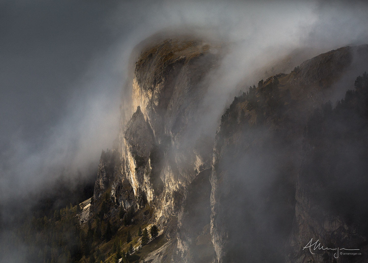 Mist wafting over a mountain face in the Dolomites, Italy